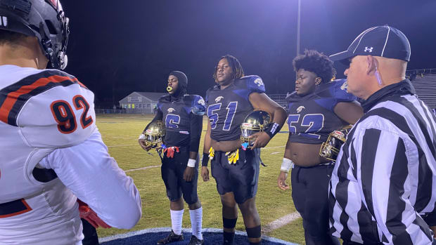 Morton's team captains Joe Laster (6), Josh Ealy (51) and Josh Lloyd (52) stand at midfield for the coin toss before the Panthers' 42-31 win over St. Stanislaus Friday night. (Photo by Tyler Cleveland)