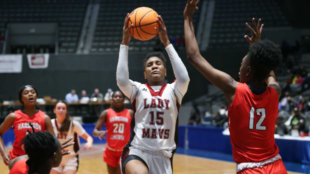 Harrison Central's Anaisha Carriere (15) drives to the basket in the second half. as Harrison Central's Laila Walker (12) defends. Germantown and Harrison Central played in an MHSAA Class 6A basketball semifinal basketball game at Mississippi Coliseum on Wednesday, March 3, 2020. Photo by Keith Warren