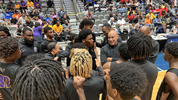 Hattiesburg coach Ernie Watson has a laugh with his players during a timeout late in the Tigers' MHSAA 5A Semifinal win over Canton.