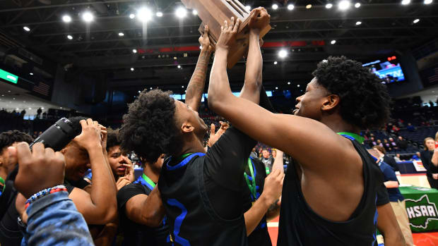 Richmond Heights players lift the 2023 OHSAA Division IV state championship trophy