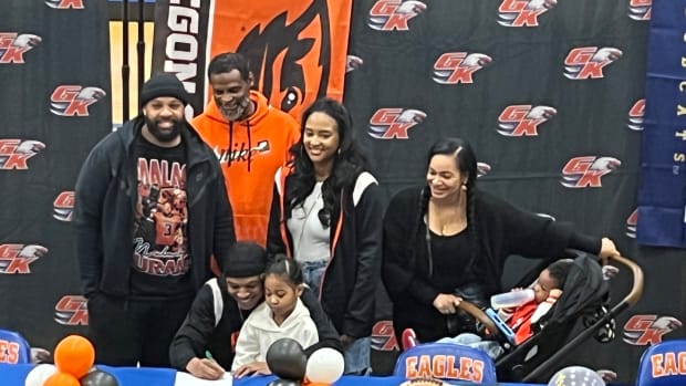 Graham-Kapowsin WR Malachi Durant signs with Oregon State University football in front of family at school gymnasium Wednesday on Signing Day.