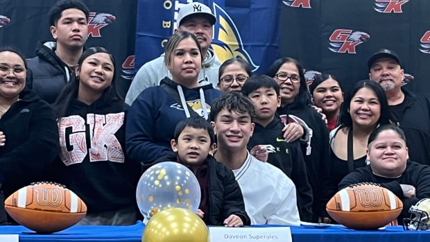 Graham-Kapowsin QB Daveon Superales signs with Montana State University football in front of family at school gymnasium Wednesday on Signing Day.
