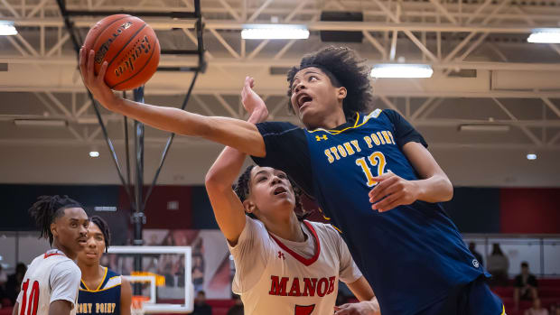 Stony Point Tigers guard Elijah Clemons (12) stretches out for the layup as Manor Mustangs guard Chris Colter Jr. (5) defends during the second period at the District 25-6A boys basketball game on Friday, Jan 19, 2024, at Manor Sr. High School - Manor, TX.
