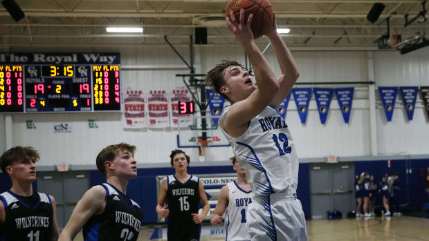 Colo-Nesco guard Mark Bower (12) takes a shot around GMG's Rider Kupka (23) and GMG's Kaleb Gill (11) during the first quarter in the 1A boys district first-round at Colo-Nesco High school's gym on Monday, Feb. 12. 2024, in Colo, Iowa.