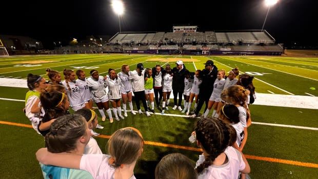 Coach Elliot Rimmer and the Clinton Lady Arrows celebrate a 2-1 win over Madison Central in the 2024 Class 7A North State Championship on Feb. 13 in Madison, Miss.