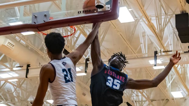 Westlake Chaparrals center Wonder Kahozi (35) bocks the slam dunk attempt by Fort Bend Clements Rangers guard Rahman Olajuwon (21) during the second period at the William Roberts Memorial Tournament on Saturday, Dec 30, 2023, at Round Rock High School - Round Rock, TX.