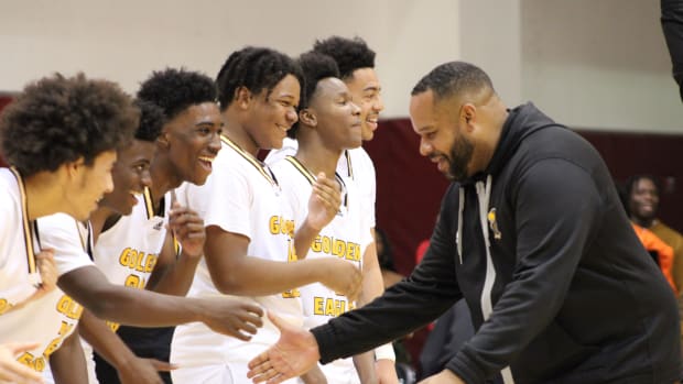 King/Drew coach Lloyd Webster celebrates with his team after beating LACES in the LA City Section Open Division final at Pasadena City College on Saturday, Feb. 24, 2024.