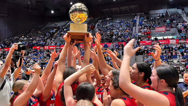 The Belmont Lady Cardinals hoist the 2023-2024 MHSAA Class 3A State Championship trophy after defeating Booneville 40-39 on Friday, March 1, 2024 at the Mississippi Coliseum in Jackson, Miss.