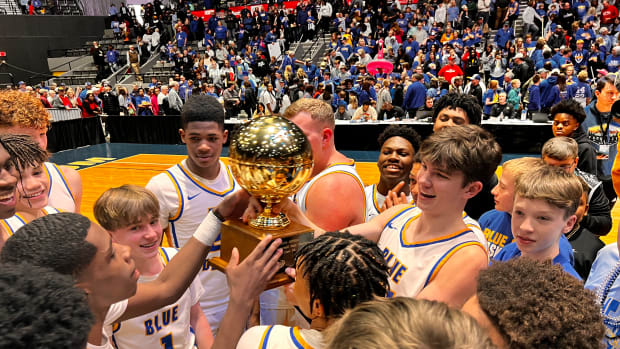 The Booneville Blue Devils celebrate a third-straight championship by hoisting the golden ball on Friday, March 1 at the Mississippi Coliseum in Jackson, Miss.