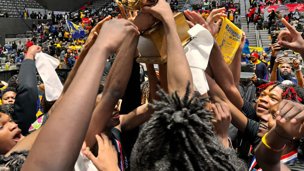 The Raymond Rangers hoist the MHSAA Class 4A State Championship Trophy after defeating McComb 53-28 on Saturday, March 2 at the Mississippi Coliseum in Jackson, Miss.