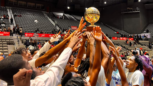 The Meridian Wildcats celebrate with the golden ball after winning the 2024 MHSAA Class 7A Championship with a 54-50 win over the Clinton Arrows on Saturday, March 2, 2024 at the Mississippi Coliseum in Jackson, Miss.
