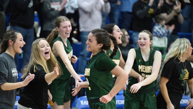 Medina's Olivia Klanac celebrates with teammates after being taken out of the game in a district final win over Archbishop Hoban on March 1, 2024.
