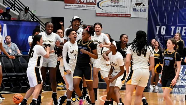 Plantation American Heritage girls basketball players celebrate after winning the Class 5A state championship on Friday at the RP Funding Center in Lakeland. 