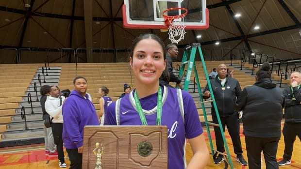 Pickerington Central's Blossom Wallace holds the Division I regional championship trophy after the Tigers defeated Bishop Watterson on March 8, 2024.
