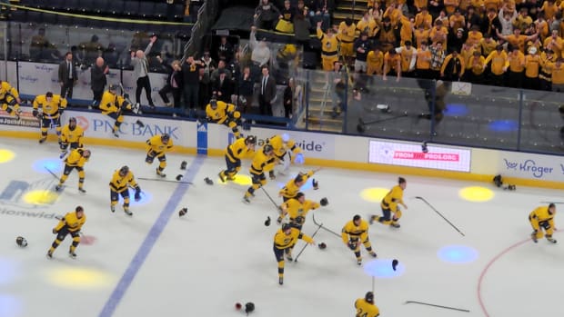 St. Ignatius players jump off the bench to celebrate winning the 2024 OHSAA hockey state championship over University School on March 10, 2024.