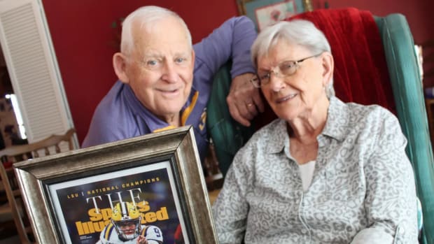 Dorothy "Dot" Ford and her husband John pose for a photo with a framed Sports Illustrated cover featuring their grandson, Heisman-winning LSU quarterback Joe Burrow. (Photo courtesy Monroe Co. Daily Journal)