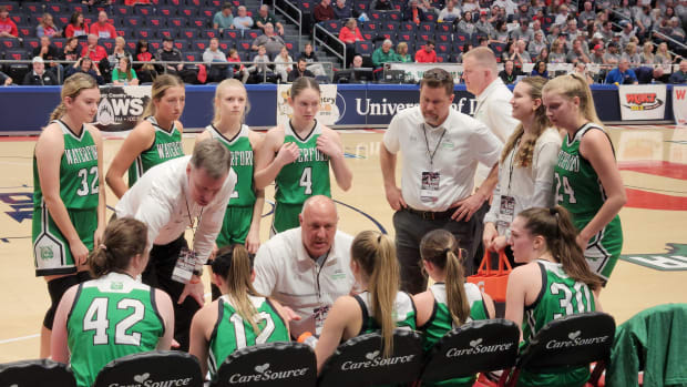 Waterford basketball coach Jerry Close talks to his team during a timeout in the OHSAA Division IV state semifinals against Loudonville on March 14, 2024.