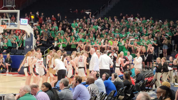 Fort Loramie players celebrate in a timeout during their Division IV state semifinal win over Crestview on March 14, 2024