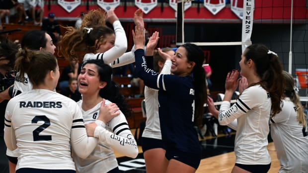 Gulliver Prep players hug and celebrate after winning the Florida Class 3A girls volleyball state championship Saturday at the FHSAA Finals at Polk State College in Winter Haven.