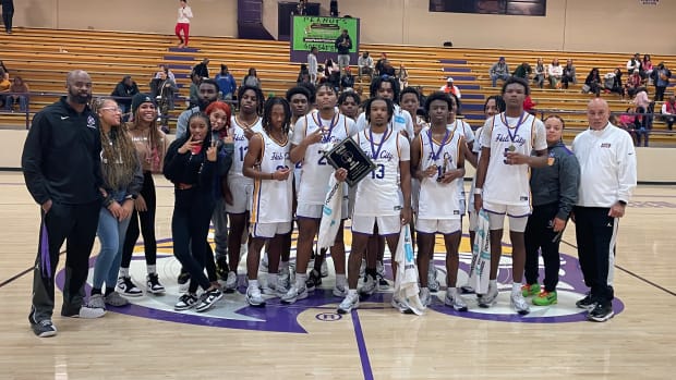 The Hattiesburg Tigers pose for a photo with the championship trophy after winning the Coca Cola Holiday Classic with a title-round win over the Brandon Bulldogs on Saturday, Dec. 30 at Hattiesburg High.
