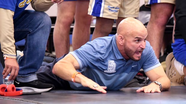 South Dade head coach Victor Balmeceda stirs his team on to victory during the Class 3A state championship duel at the FHSAA Duals this past season at Osceola High School in Kissimmee.