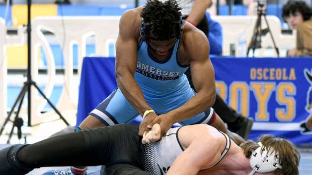 Somerset’s Kendrick Hodge battles to a 18-5 major decision win over Benjamin Lewis from Suwannee during a 165-pound finals match on Saturday at the FHSAA Duals wrestling state championships at Osceola High School