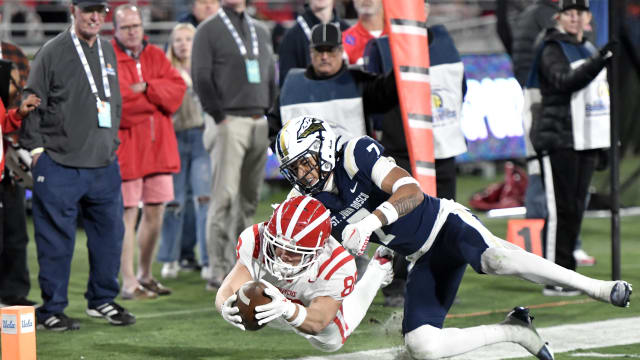 Mater Dei's Jack Ressler leaps for the goal line while defended by St. John Bosco's Peyton Woodyard during the teams' second meeting of 2022.
