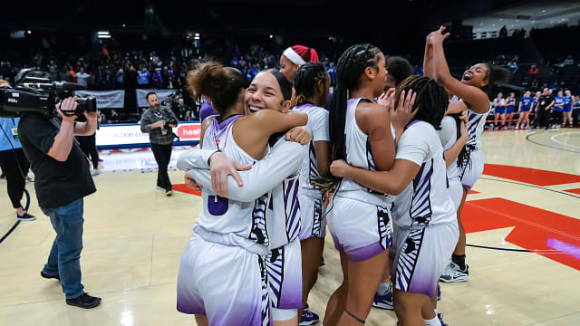 Africentric girls basketball players celebrate winning the 2023 Division III state championship.