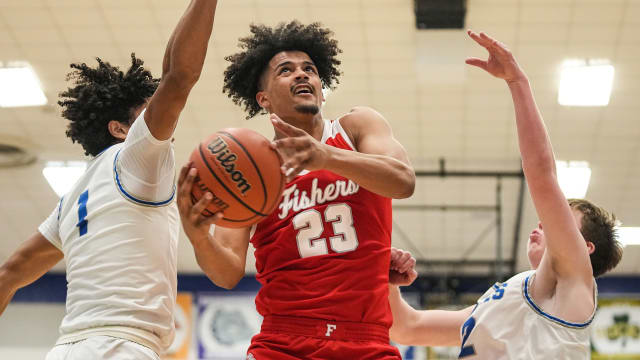Fishers Tigers forward Keenan Garner (23) attempts to score against Hamilton Southeastern Royals Donovan Hamilton (1) on Friday, Dec. 15, 2023, during the game at Hamilton Southeastern High School in Fishers. The Fishers Tigers defeated the Hamilton Southeastern Royals, 64-57.