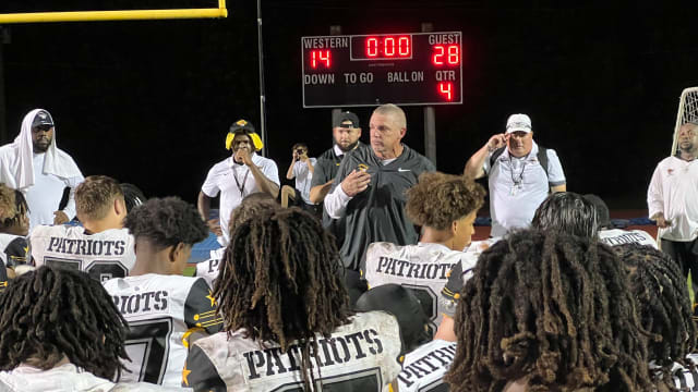 American Heritage coach Mike Smith addresses his team after its 28-14 victory over Western on 10-6-2028.