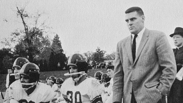 A young Joe Biden (30) crouches beside Archmere Academy football coach John Walsh in 1960.