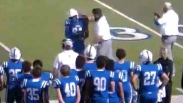 A Jesuit Catholic football coach punches one of his players as he exits the playing field.