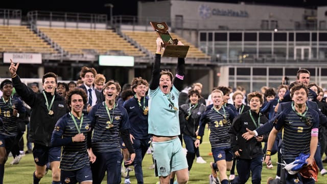 St. Ignatius soccer players celebrate winning the 2023 Division I state championship on November 11, 2023