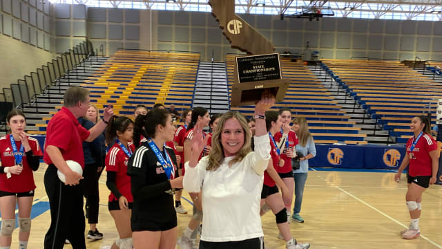 Glendale coach holds up 2023 CIF D4 girls volleyball state trophy by Michelle Bamford 11-18-23