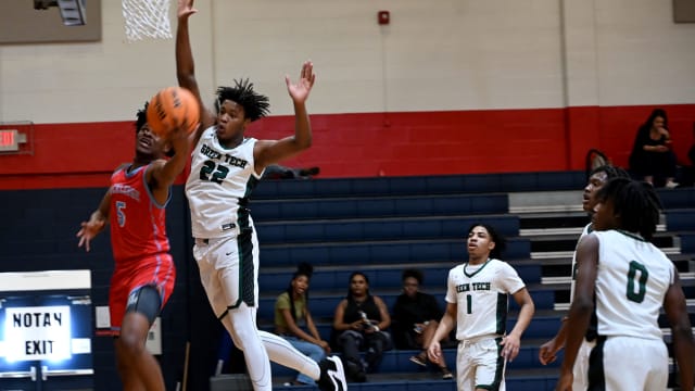 Kiori Jordan-Thomas from Rockledge drives under the basket while Olivan Owens from Albany Green Tech defends during the fifth-place game at the Kingdom in the Sun Tournament at Vanguard High School in Ocala. 