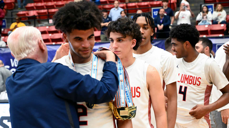Cayden Boozer from Miami Columbus recieves his state championship medal after winning the FHSAA Class 7A state title on Saturday at the RP Funding Center in Lakeland.