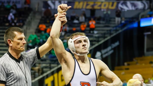 Palmyra's Collin Arch throws up four fingers to note his fourth state championship. 