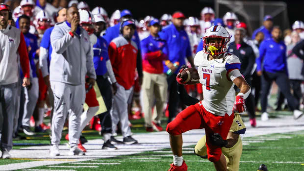 DeMatha running back Bud Coombs heads downfield for a key 16-yard run on 4th down in the fourth quarter of Friday's WCAC matchup with Good Counsel. The junior finished with 134 yards and a touchdown for the Stags, who suffered their first loss in a 35-28 overtime decision.