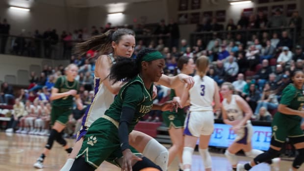 Guarded by Lumpkin County's Mary Mullinax, Wesleyan's Chit-Chat Wright scans the defense before making her move. Mullinax and Wright were each named Co-Region Players of the Year, but Wright proved to be the most dynamic player on the floor, Saturday, with a game-high 26 points.