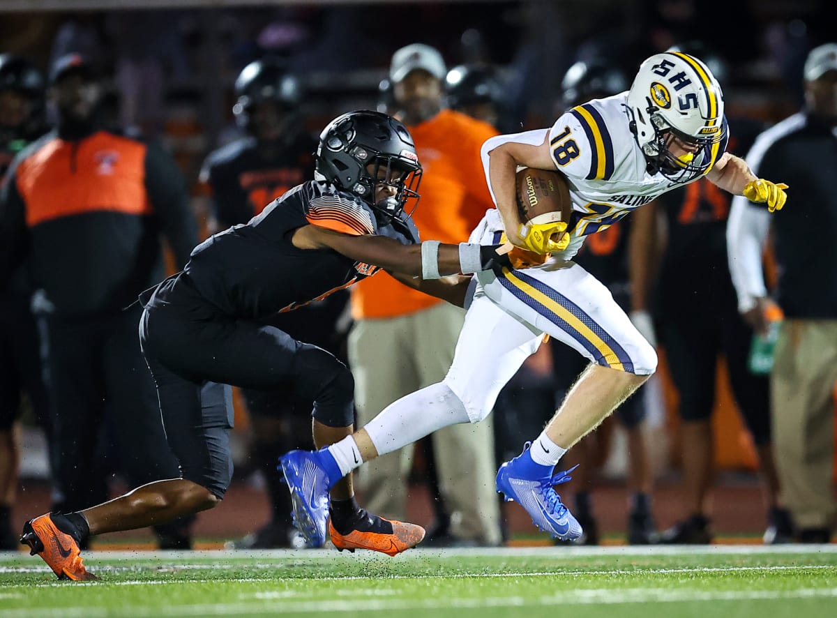 Belleville Tigers Dominate Saline Hornets with 65-14 Victory