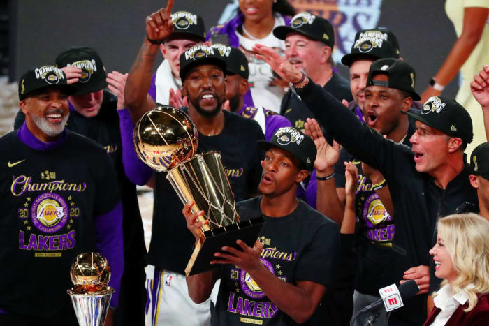 Los Angeles Lakers guard Rajon Rondo (9) holds the trophy as he celebrates with teammates after game six of the 2020 NBA Finals. The Oak Hill 