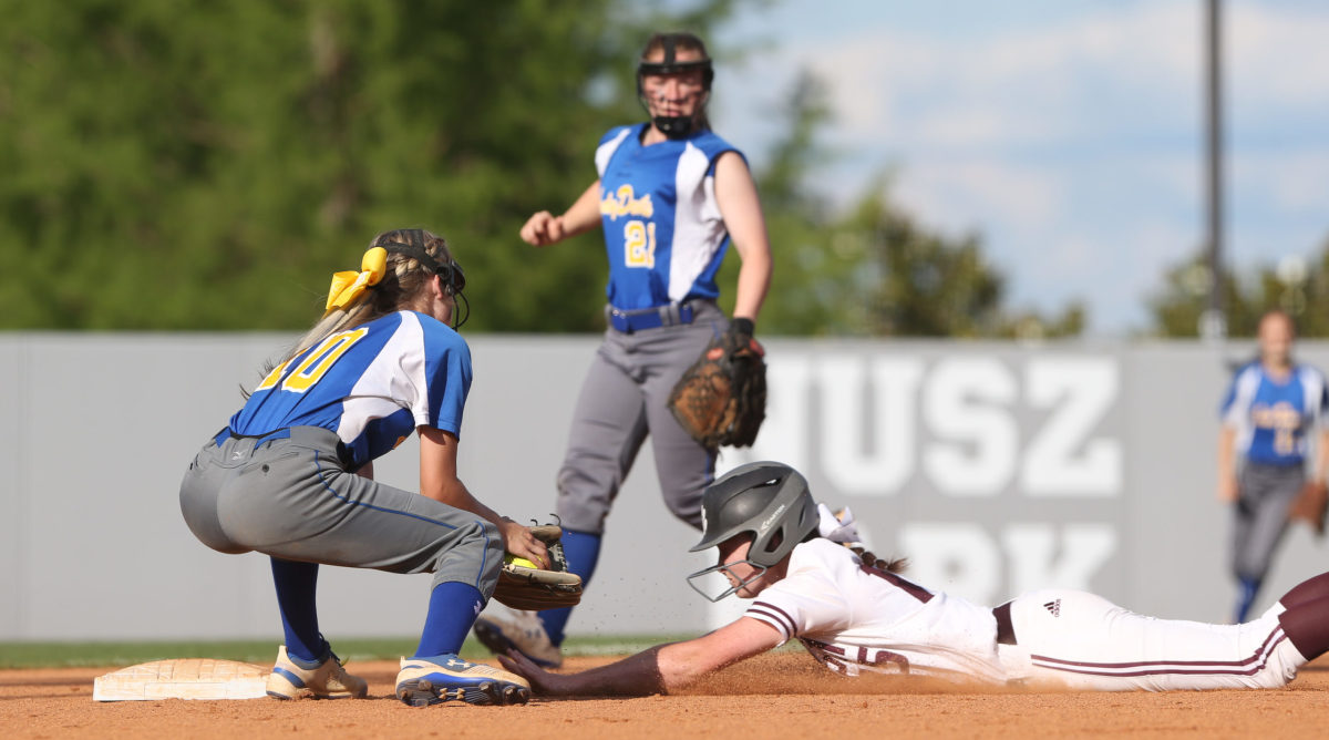 Booneville High School's Shaylea King (10) attempts to tag out Raleigh High School's Hayley  Revette (15). Booneville and Raleigh played in game two of the MHSAA Class 3A Baseball Championship at Mississippi State University on Thursday, May 13, 2021. Photo by Keith Warren