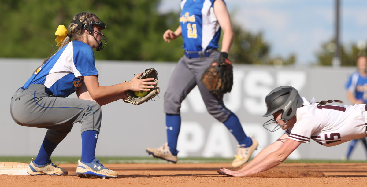 Booneville High School's Shaylea King (10) attempts to tag out Raleigh High School's Hayley  Revette (15). Booneville and Raleigh played in game two of the MHSAA Class 3A Baseball Championship at Mississippi State University on Thursday, May 13, 2021. Photo by Keith Warren