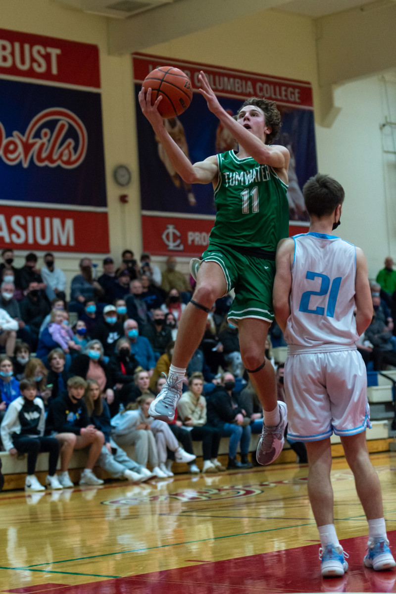 Tumwater's Luke Brewer makes a transition layup in a Lower Columbia College's Martin Luther King Jr. Tribute game on Monday, Jan. 17, 2022, at Myklebust Gymnasium in Longview. Tumwater won 64-52 over Mark Morris. (Joshua Hart/For ScorebookLive)