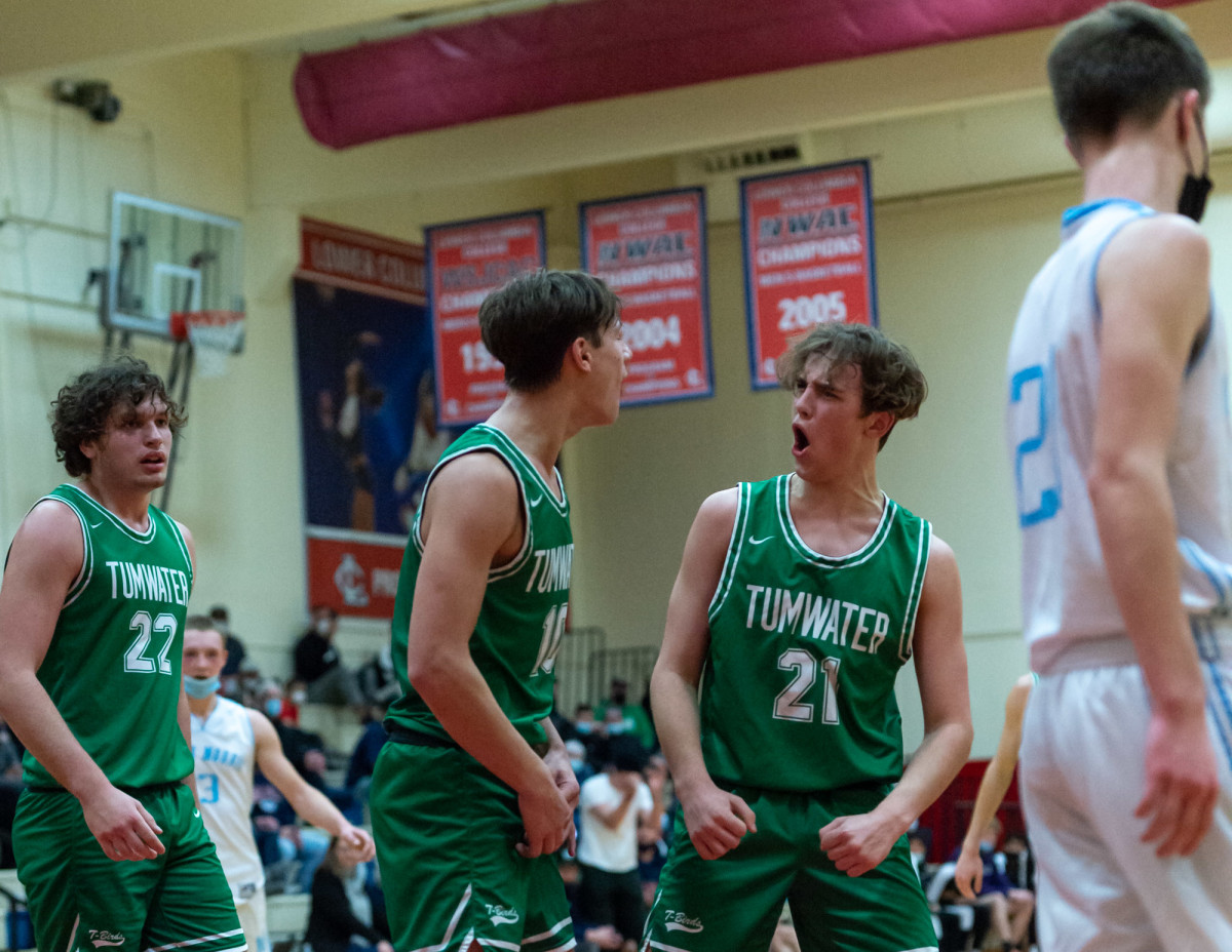 Tumwater's Andrew Collins, left, and Connor Hopkins, right, celebrate in a Lower Columbia College's Martin Luther King Jr. Tribute game on Monday, Jan. 17, 2022, at Myklebust Gymnasium in Longview. Tumwater won 64-52 over Mark Morris. (Joshua Hart/For ScorebookLive)