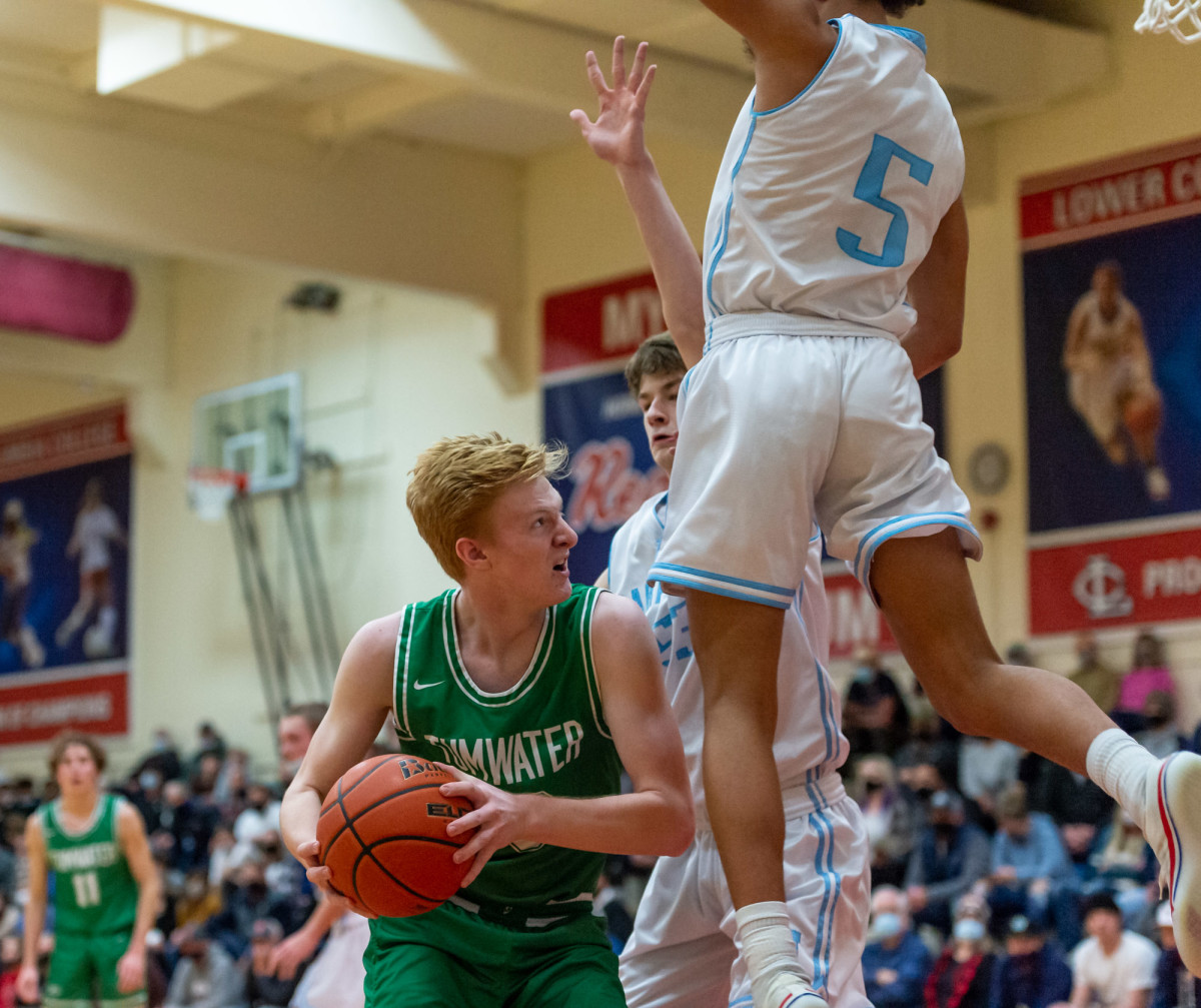 Tumwater's Adam Overbay draws a foul in a Lower Columbia College's Martin Luther King Jr. Tribute game on Monday, Jan. 17, 2022, at Myklebust Gymnasium in Longview. Tumwater won 64-52 over Mark Morris. (Joshua Hart/For ScorebookLive)