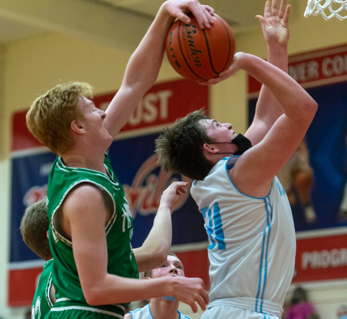 Tumwater's Adam Overbay blocks Mark Morris' Dossen Morrow in a Lower Columbia College's Martin Luther King Jr. Tribute game on Monday, Jan. 17, 2022, at Myklebust Gymnasium in Longview. Tumwater won 64-52 over Mark Morris. (Joshua Hart/For ScorebookLive)
