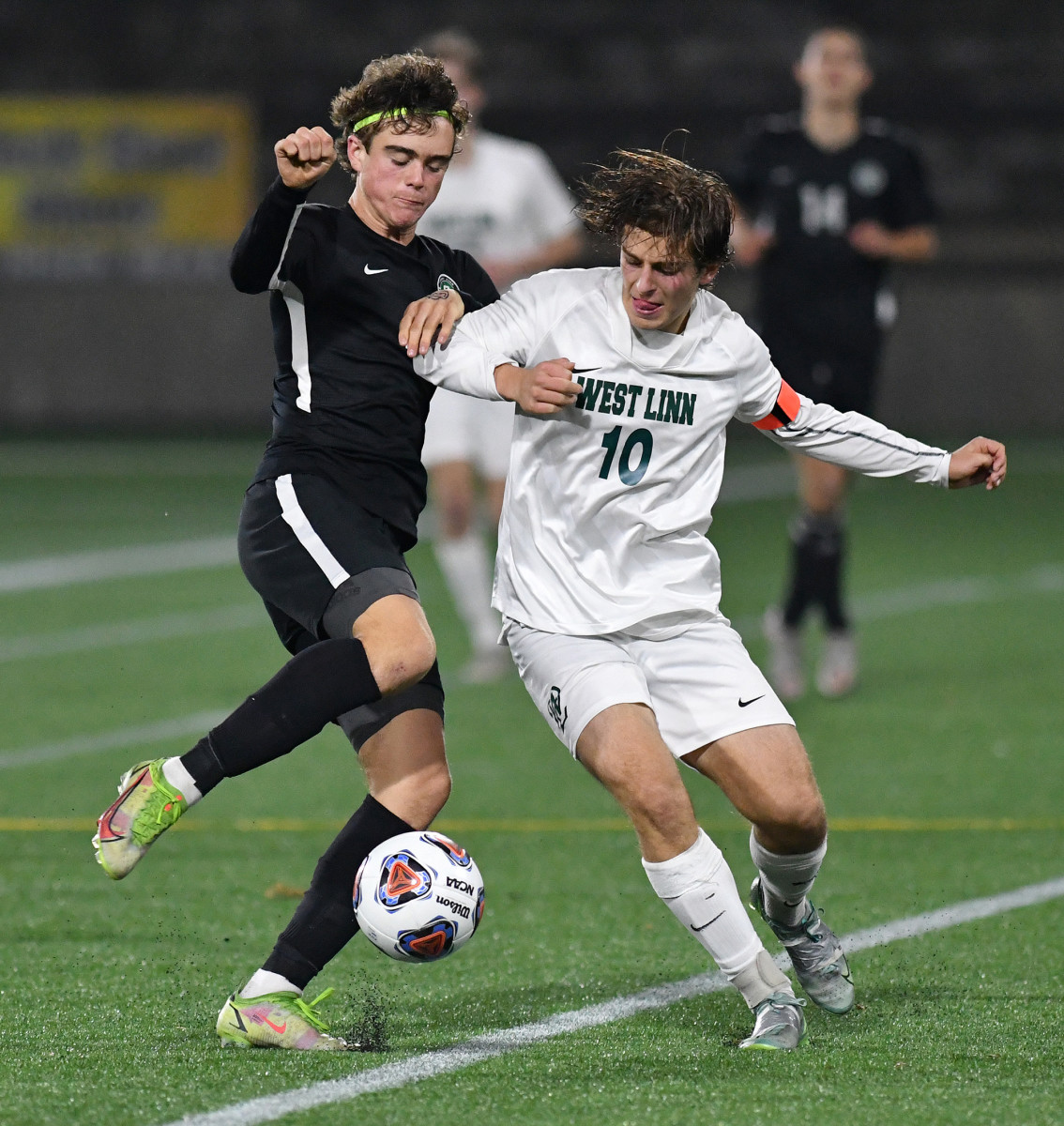 Summit junior Ben Evans, left, fights off West Linn senior Owen Caba on Saturday, Nov. 13, 2021, during the Storm’s 6-0 win against West Linn in the OSAA 6A Boy’s state championship game at Hillsboro Stadium in Hillsboro.
