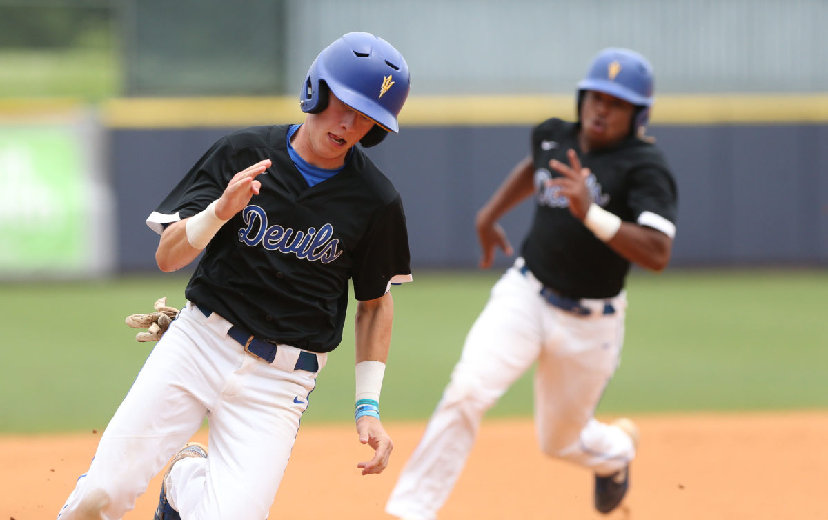 Booneville's Ben Sandlin (15) and Booneville's Zion Young (10) head to third base and eventually score on the play. Booneville and Magee played in game 3 of the MHSAA Class 3A Baseball Championship on Saturday, June 5, 2021 at Trustmark Park. Photo by Keith Warren