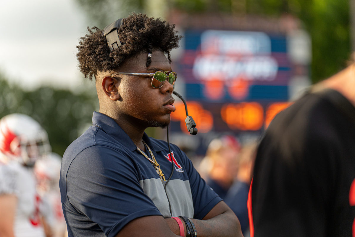 Week 2: Injured defensive star Lebbeus Overton takes on the role of “Coach LT” for Milton at North Cobb. (Photo by Josh Major)